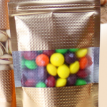 B12 ถุงหน้าใส-หลังทอง เจาะหน้าต่าง ติดซิป ขนาด 9*13+3 ซม